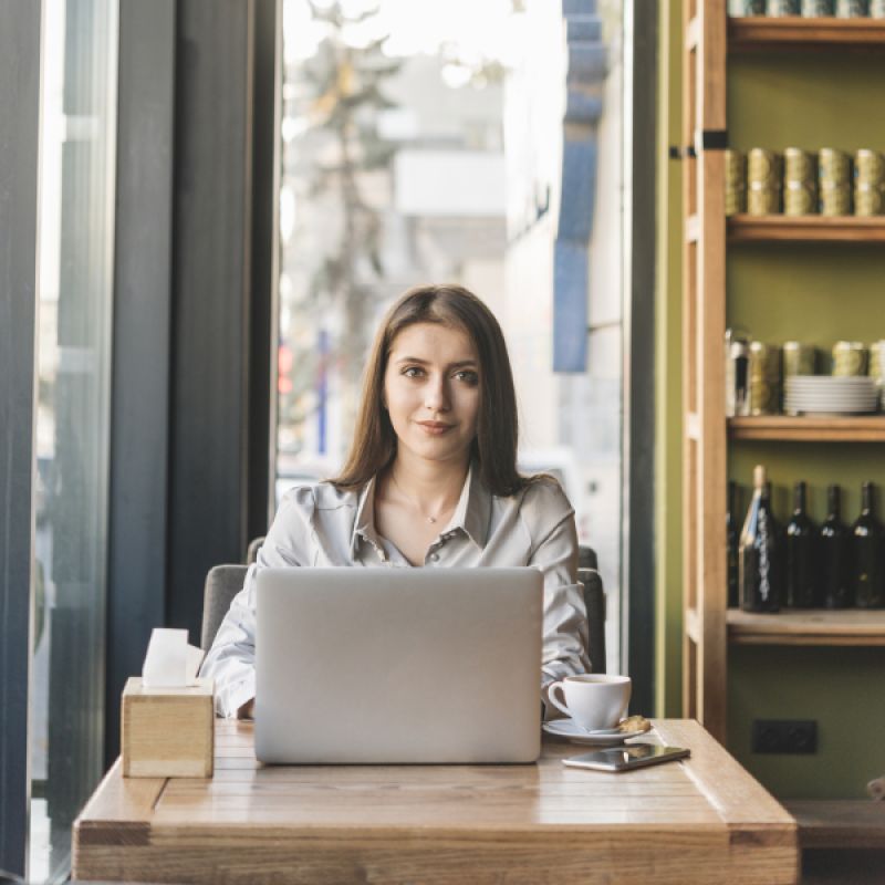 a girl working on laptop smiling 